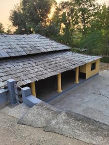 a building with a roof on top of it at Commander's Home in Kangra +16 photos