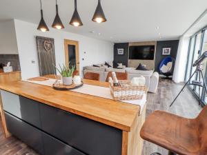a kitchen and living room with a counter top at The Joiners Cottage in Morpeth