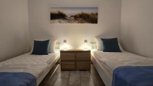 a room with two beds and a table with lamps at CENTRO POOL House in Novalja +29 photos