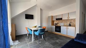 a kitchen and dining room with a table and chairs at CENTRO POOL House in Novalja