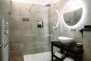 a bathroom with a sink and a glass shower at Villa Dolce in Silly
