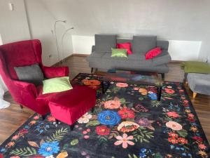 a living room with two chairs and a couch at Fewo extraschön - Dachgeschoss in Lindau