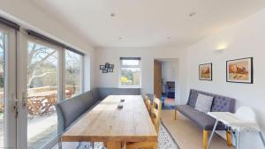 a living room with a wooden table and a couch at Town Furze in Oxford