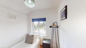 a living room with a white couch and a window at Town Furze in Oxford