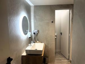 a bathroom with a sink and a mirror at Best Western Hotel Le Crystal Dinard in Dinard