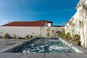 a swimming pool in the backyard of a house at Essence Villas - Garden & Spa in Ribeira Grande