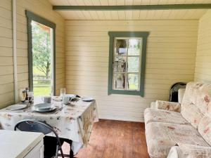 a room with a table and a couch and a window at Cwt Tyddyn Shepherd's Hut in Corwen +15 photos