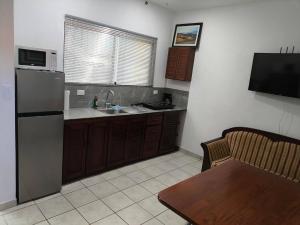 a kitchen with a refrigerator and a sink and a table at Marina Loft unit 2 floor, 201 in Coco +2 photos