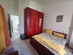 a bedroom with a bed with a red door at Modern Luxury Villa Steps from the Sea North Coast in Borg El Arab
