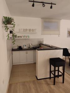 a kitchen with a counter and a stool in a room at Apartman Centar Surcin 2 in Surčin +10 photos