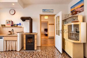 a kitchen with an old stove in a room at Kovárna Klapý pod Hazmburkem - České středohoří in Klapý +42 photos