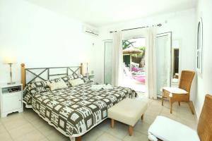 a bedroom with a large bed and a balcony at Villa Reco by Villa Plus in Felanitx +24 photos