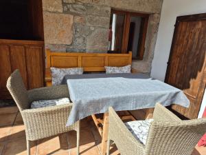 a table and chairs with a blue table cloth on it at Loft Miradas al Sella in Corigos