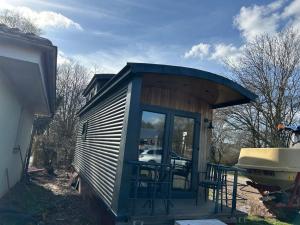 a tiny house with a porch and a grill at Tiny Haus roter Wagen in Langenselbold