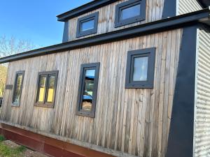 a house with windows on the side of it at Tiny Haus roter Wagen in Langenselbold +8 photos