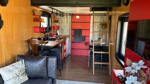 a kitchen and living room in a tiny house at Tiny Haus roter Wagen in Langenselbold