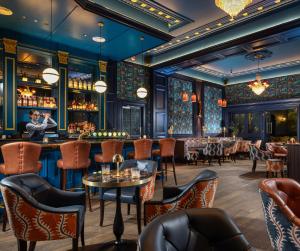 a restaurant with a bar and tables and chairs at The Grand Hotel in Malahide +63 photos