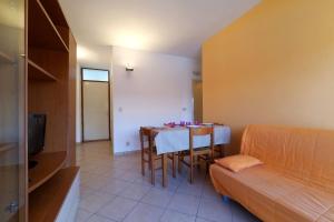 a small room with a table and a bed at Appartamenti Eco del Mare in Lido di Pomposa +8 photos