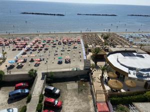 an aerial view of a beach with chairs and umbrellas at Appartamenti Eco del Mare in Lido di Pomposa