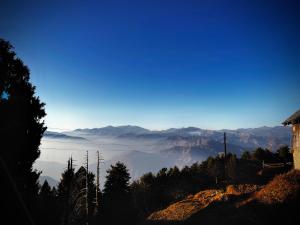 a view of the mountains and clouds in the sky at Smarthill Deodar Echoes in Dalhousie +13 photos