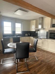 a kitchen with a table and chairs in it at Fewo extraschön - Dachgeschoss in Lindau +8 photos