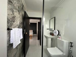 a bathroom with a toilet and a sink at Casa-Pel Villa Grande in Palatswe +42 photos