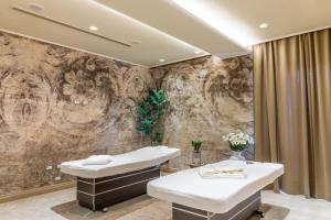 a bathroom with two sinks and a stone wall at Hotel Villa Pascucci in Durrës +42 photos
