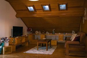 a living room with a couch and a tv at Casa dos Avós in Parceiros da Igreja