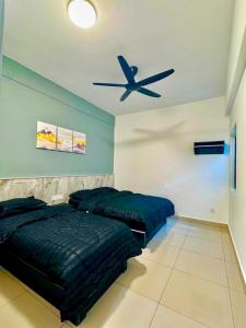 a bedroom with two beds and a ceiling fan at Cloud Nine Homestay in Tanah Rata
