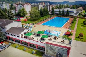 an overhead view of a swimming pool in a city at Alexandra Šport Hotel in Púchov