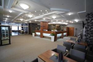 an office with a waiting room with tables and chairs at Alexandra Šport Hotel in Púchov