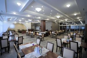 a restaurant with tables and chairs in a room at Alexandra Šport Hotel in Púchov