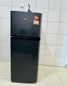a black refrigerator with a sticker on it at Cloud Nine Homestay in Tanah Rata +11 photos