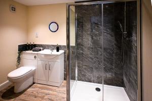 a bathroom with a shower with a toilet and a sink at Hope Cottage in Hythe +30 photos