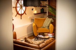 a living room with a couch and a chair at Stay at Plattens in Wells next the Sea