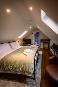 a bedroom with a large bed in a attic at Stay at Plattens in Wells next the Sea