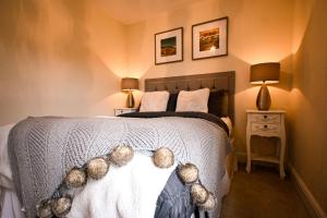 a bedroom with a bed with teddy bears on it at Hope Cottage in Hythe