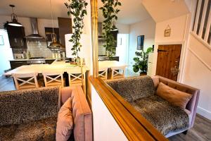 a living room with a couch and a dining room at Hope Cottage in Hythe