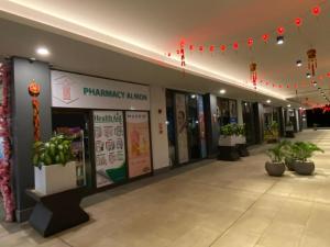 a building with potted plants and red lights at SéjourdétenteàMaurice in Albion