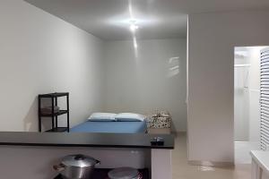 a bedroom with a bed in a white room at Chalés do Mako in São Sebastião +9 photos