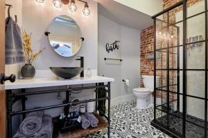 a bathroom with a sink and a mirror at Studio 1892 Guesthouse in Hermann