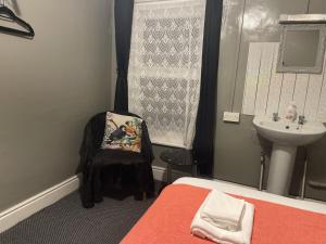 a small bathroom with a bed and a sink at Coconut Cove in Blackpool +4 photos