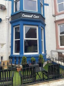 a blue building with a table in front of it at Coconut Cove in Blackpool
