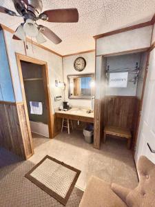 a bathroom with a sink and a clock on the wall at Starlite Motel in Seneca