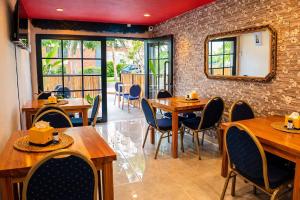 a restaurant with wooden tables and chairs and a mirror at DUO BOUTIQUE HOTEL in Medellín