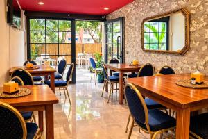 a restaurant with wooden tables and chairs and a mirror at DUO BOUTIQUE HOTEL in Medellín