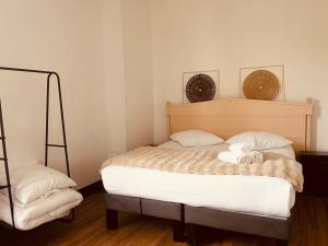 a bedroom with a bed with two towels on it at Hôtel de la paix in Limoges
