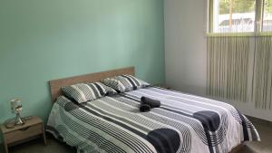 a bedroom with a bed with a stuffed animal on it at Villa turquoise - piscine privée, terrasse bois in Saint-Jean-de-Monts +15 photos