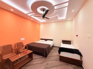 a room with two beds and a ceiling at Italian cafe Hampi in Hampi