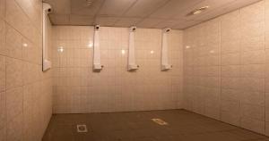 a room with a shower with white tiled walls at Mõedaku Puhkekeskus in Mõedaka +13 photos